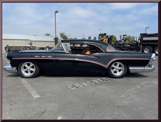 Classic black car in parking lot