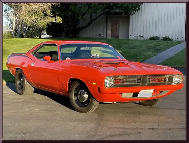 Classic orange muscle car parked outdoors