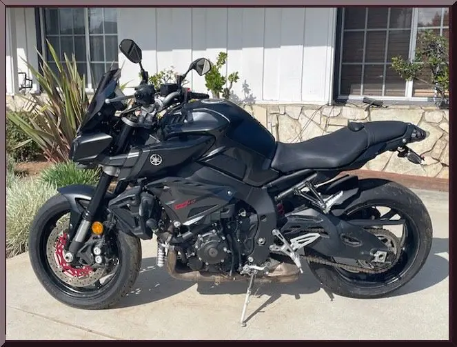 Black sport motorcycle parked outside house