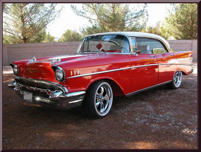 Classic red vintage car under trees