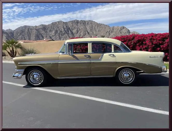 Beige vintage car near red flowers