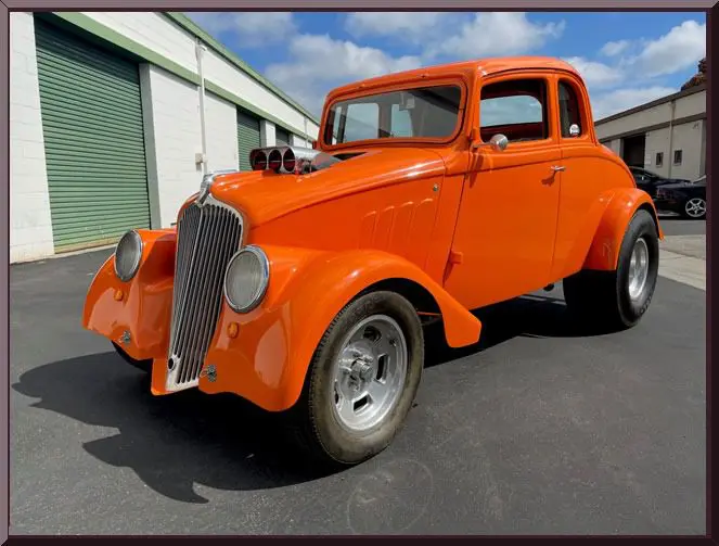 Classic orange hot rod in sunlight