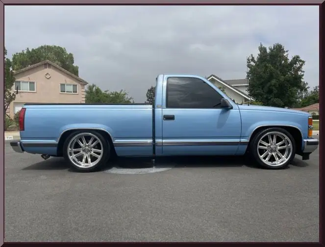 Custom blue truck in suburban area