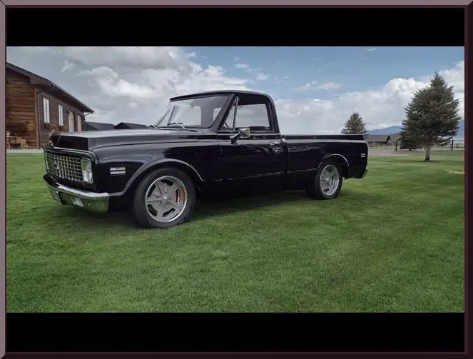 Black pickup in countryside setting